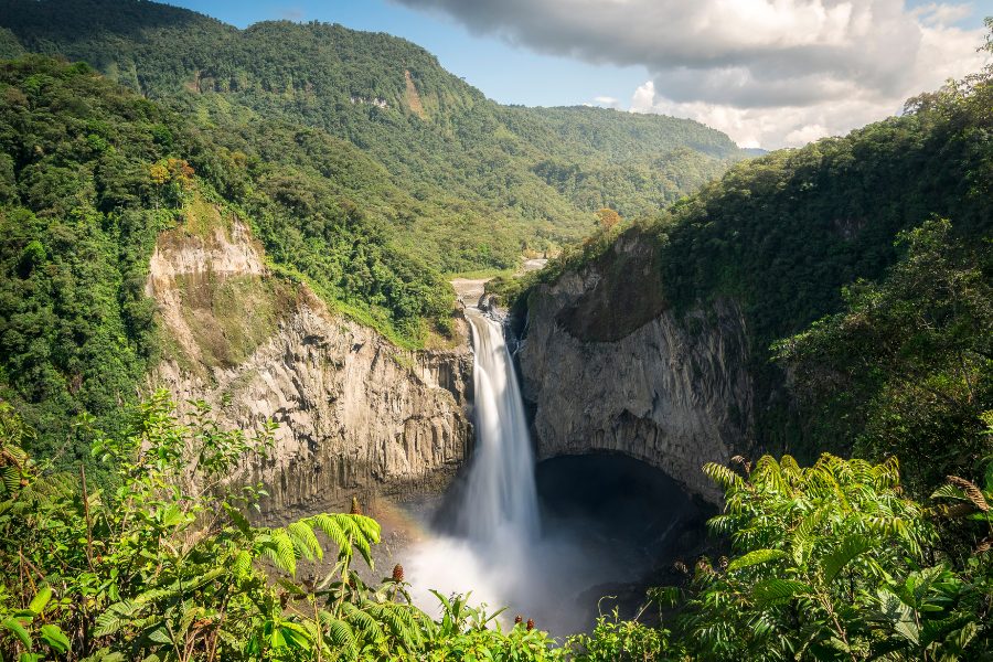 A tall waterfall surrounded by lush green rainforest in Ecuador, showing the country’s tropical beauty and wild landscapes.