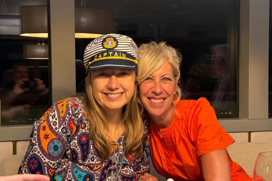 Brighde and Colleen smiling during Captain’s Dinner on the superyacht in Croatia.