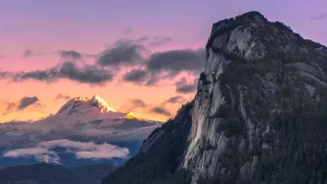 Scenic view of Squamish with Stawamus Chief mountain and highway at sunset.
