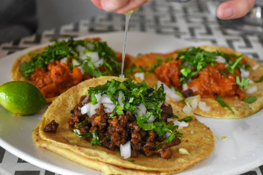 Three vegan tacos with cilantro and onion in Mexico City on Mena's tour.
