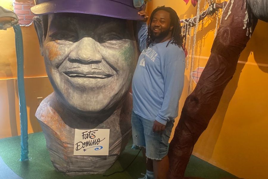 Original Simmons standing next to a Fats Domino statue in New Orleans