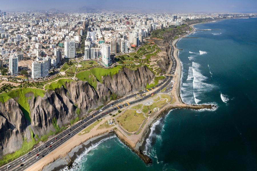 Aerial view of Lima cliffs, city buildings, and ocean coastline
