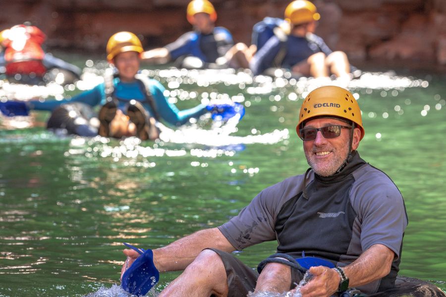 Group floating in canyon water with helmets in Karijini National Park