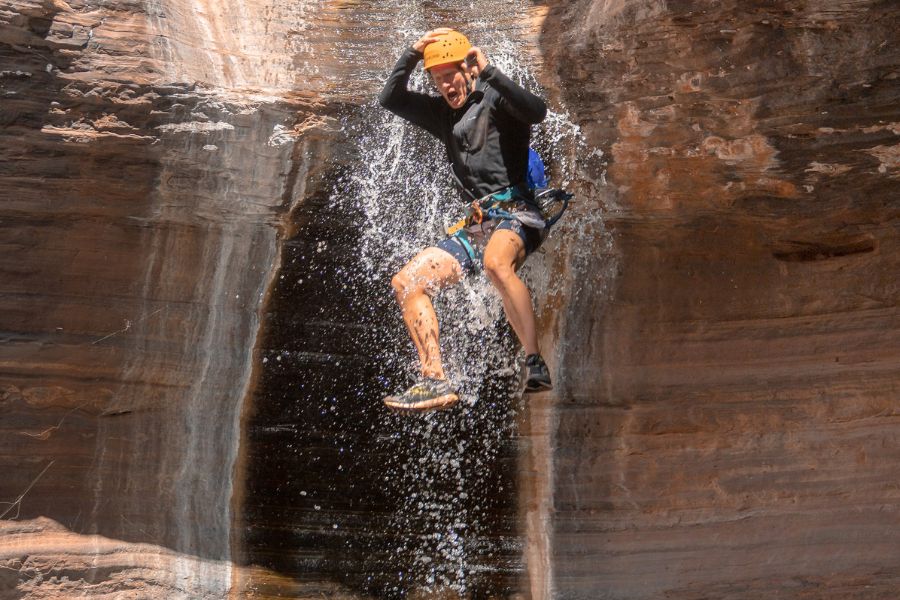 Person jumping into water in a canyon in Karijini National Park