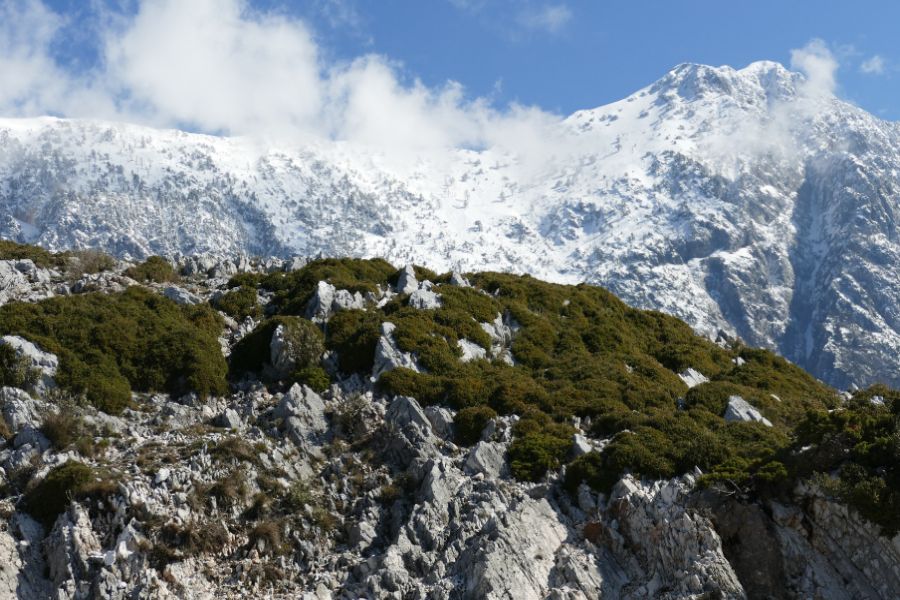Gjirokaster castle stands in front of snowy mountains in Albania. A must-see stop on an Albania road trip.
