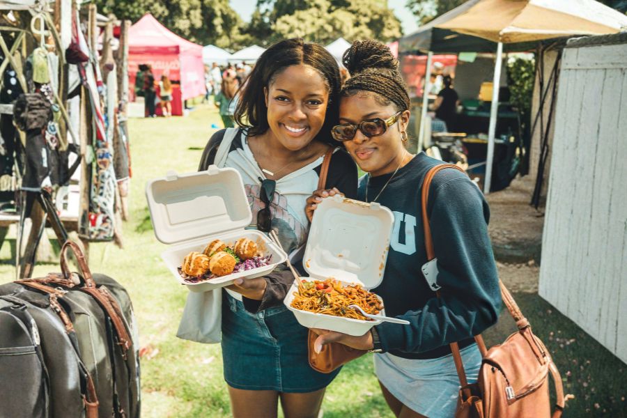 People enjoying food at San Diego vegan events outdoor market
