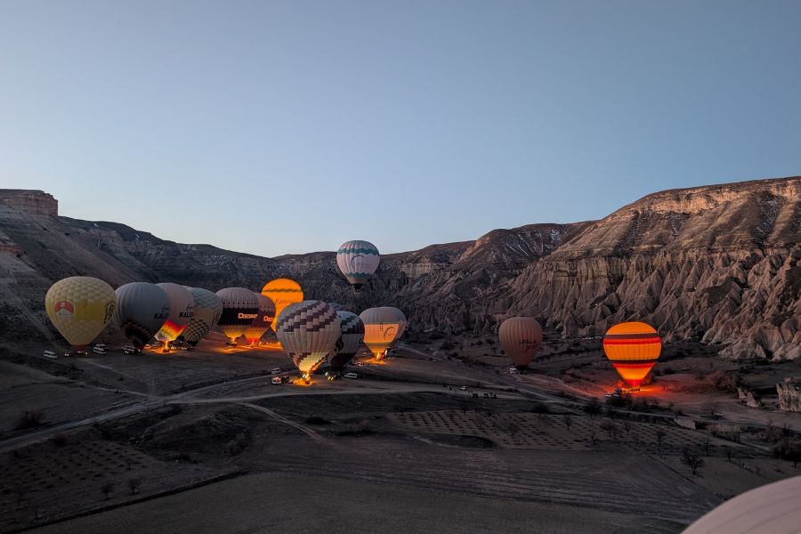 Hot air balloons flying over Cappadocia Turkey at sunrise