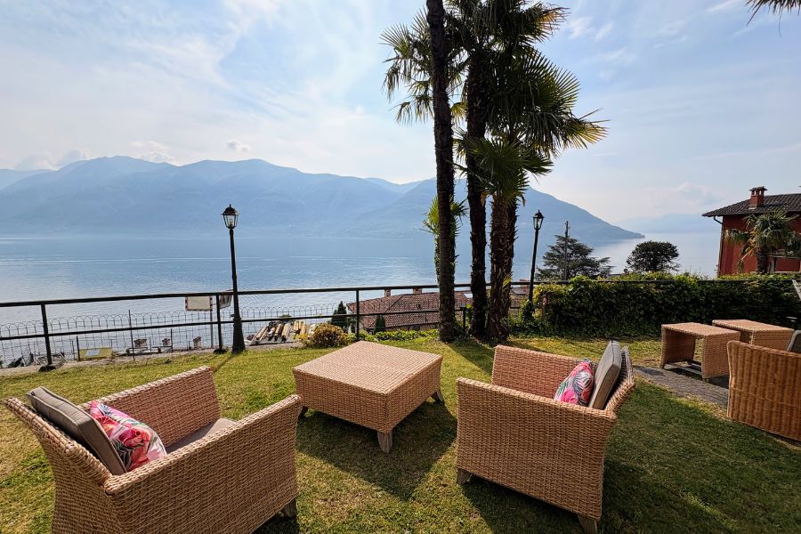 Garden seating at vegan hotel in Switzerland overlooking Lake Maggiore