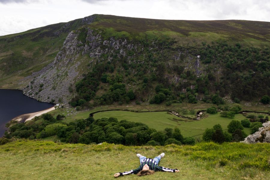 Kiara relaxing in a green valley during a peaceful travel moment