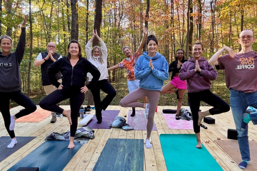 Group yoga on an outdoor deck at Raven’s Retreat Hocking Hills in Ohio.