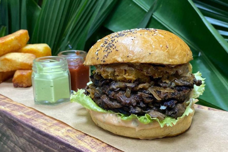Vegan smash burger with fries and sauces served in Trinidad and Tobago