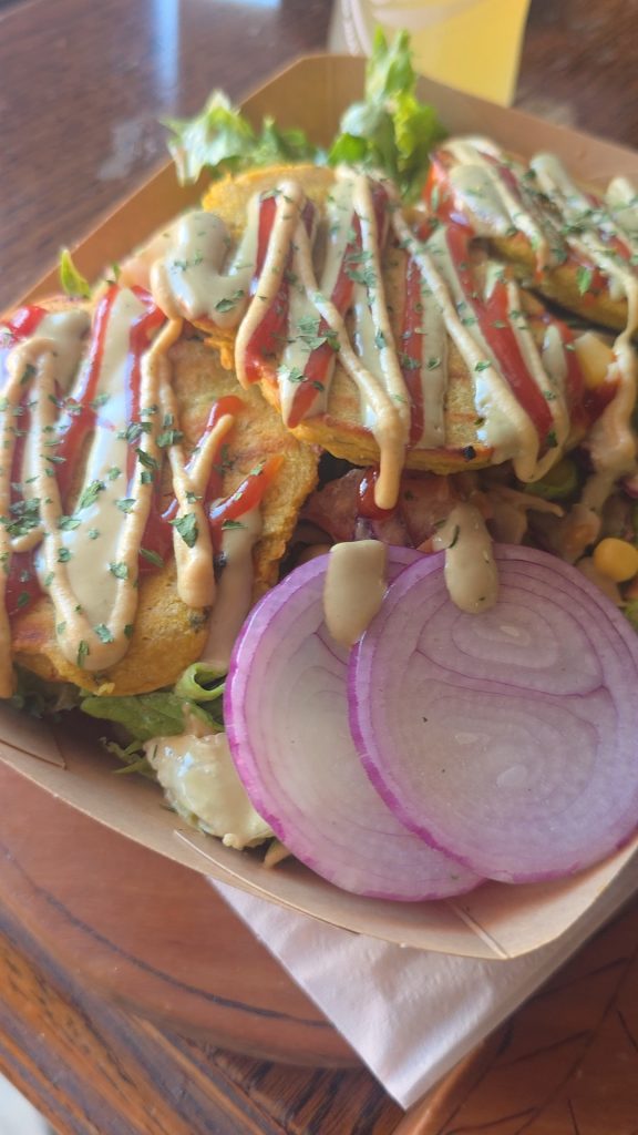 Vegan salad with chickpea fritters and creamy sauces at Public Vegan Kitchen