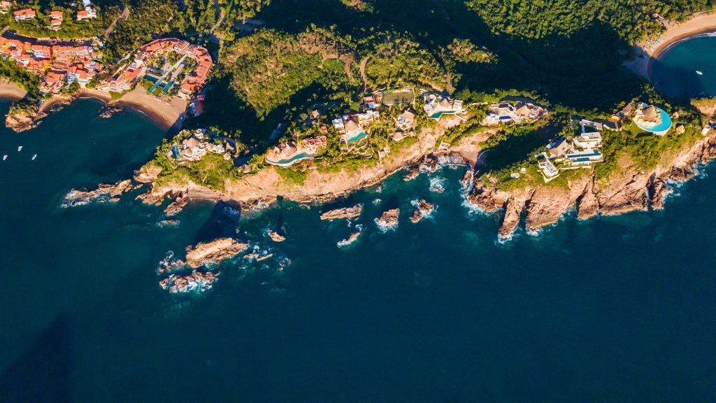 Aerial view of colourful villas and rocky coastline in Careyes, Mexico