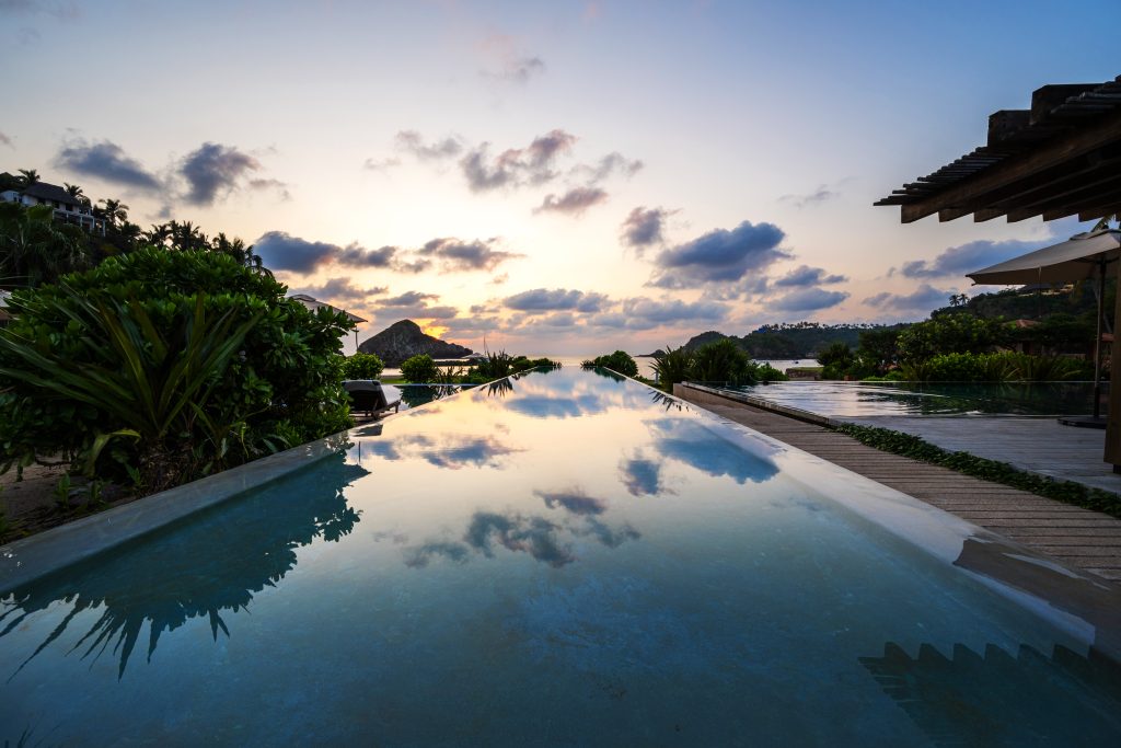 El Careyes Club infinity pool overlooking the Pacific Ocean at sunset
