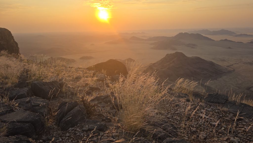 Golden sunset over rugged mountains and desert valleys in Namibia