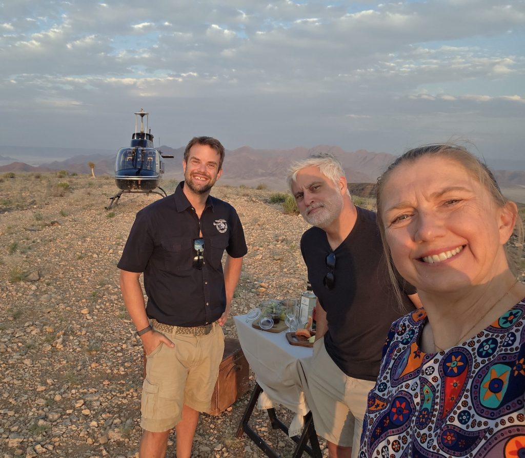 Brighde and Seb with their helicopter in the Namib Desert