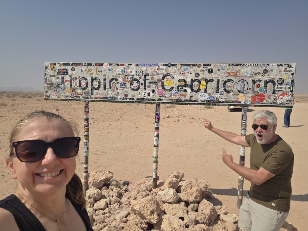 Brighde and Seb at the Tropic of Capricorn sign in Namibia